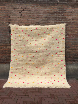 carpet with dots on brick wall