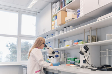 Researcher Working With Microscope