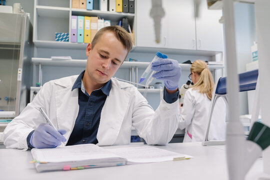 Researcher At Laboratory Taking Notes