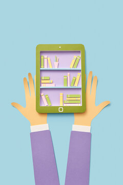 E-book screen in the hands handmade from paper.