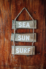 "Sea, sun, surf" wood sign