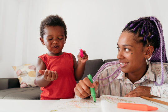 Mother and son drawing at home