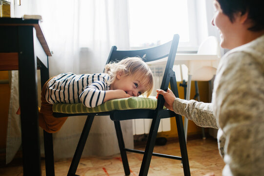 Young woman and her little daughter in the kitchen