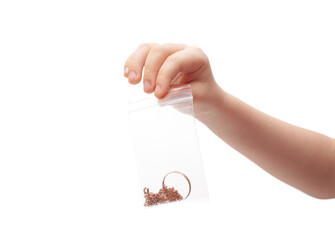 Hand holds a transparent package with gold jewelry