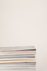 stack of magazines against white background, empty space for text