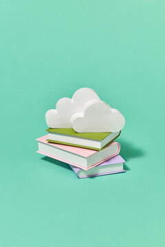 Handcraft paper books library with white clouds.