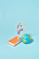 Papercraft schoolboy with paper book and globe.