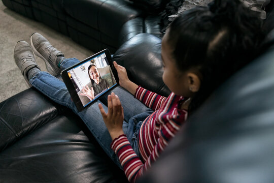 Home: Girl Using Tablet To Video Call With