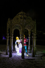 Creative colorful figure of a prince with cinderella in the arch made as a lantern on a black background. 13 March 2021, Lantern festival, Minsk, Belarus