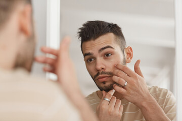 Young Man Applying Face Cream