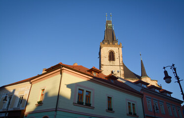 Fototapeta na wymiar Gothic Church of St Nicholas in Louny town, Czech Republic. Church from 16. century designed by royal architect Benedikt Rejt. Stone church tower. Tented roof in gothic architecture. 