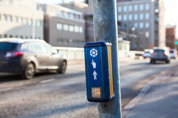Push button to cross the street with driving cars
