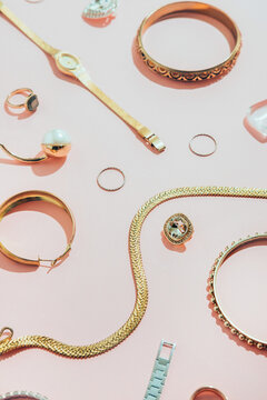 Jewellery,diamonds, ruby, gold, silver etc/ on pink background