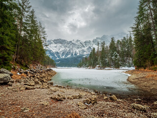 Winter view to the frozen lake and the Zugspitze at the background