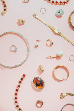 Jewellery,diamonds, ruby, gold, silver etc/ on pink background