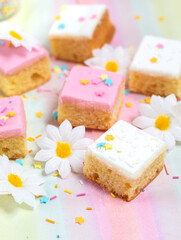 Pieces of Madeira cake with white and pink icicng
