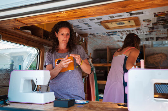 Entrepreneur women travelling in upcycling clothes caravan