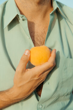holding a peach.