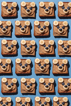 Cute bear face toasts with peanut butter, banana and blueberries
