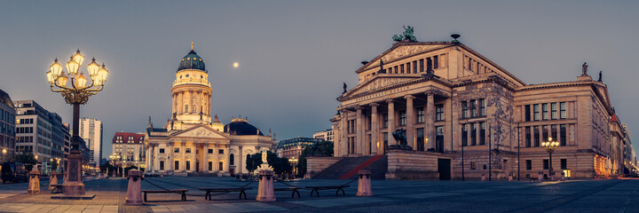 Panorama image of Gendarmenmarkt square in Berlin with German church and Concert Hall at dawn