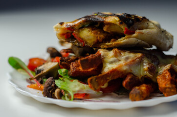 Grilled tortilla wrap with southern style chicken breast with sweet potato fries served on the mix salad