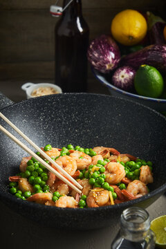 Palatable shrimps in frying pan in kitchen