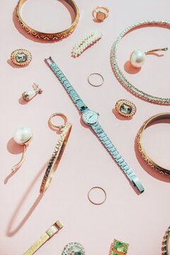 Jewellery,diamonds, ruby, gold, silver etc/ on pink background