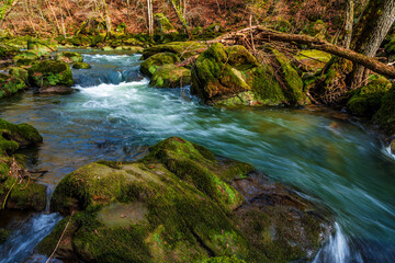 Naklejka na ściany i meble The rapids in the lower reaches of the Prüm near Irrel in the Eifel, Germany..The Irrel waterfalls of the Prüm.