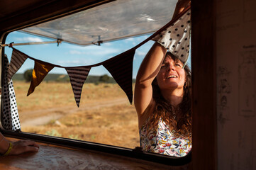 Woman decorating van with flags