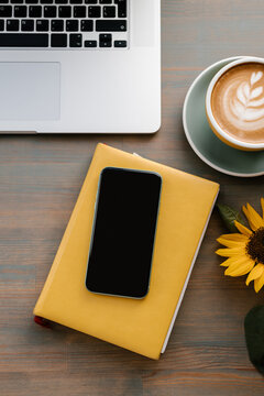 Cozy workplace with gadgets and coffee