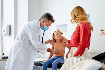Pediatrician examining a child