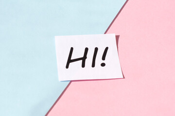 The word hi against a colored background. Greeting and welcoming in hospitality business concept.