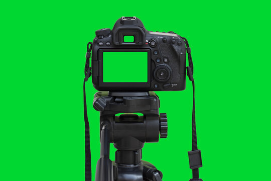 Dslr camera with green screen on the tripod isolated on green background.  Green screen camera