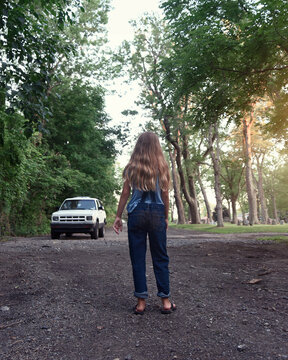 Girl Walking Alone Looking at Strange Car