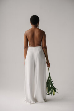 The back of african woman with lily flowers