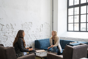 Friends Meeting In Cozy Coffee Shop