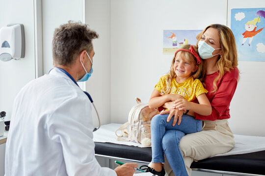 Pediatrician talking to his patient