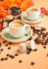 Capsules for an espresso machine in hand. Aromatic Italian coffee . Arabica coffee beans for the preparation of a traditional drink. Vertical . High quality photo