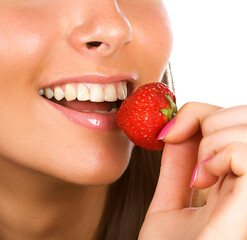 brunette girl eating a strawberry