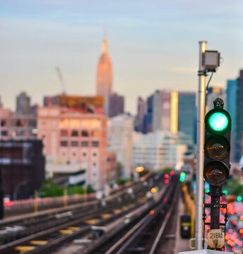 Green Light For The Train On A Train Platform, Looking Out On To The NYC Skyline As A Background