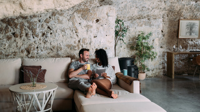 Young couple resting on sofa in creative living room