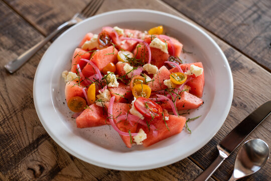 Watermelon salad on wooden table.