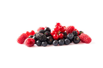 Ripe berries and fruits isolated on white background. Juicy and delicious raspberries, currants, mulberries, blackberries, blueberries. Mixed berries with copy space for text. Various fresh summer.
