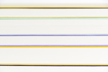 Background, front view of a pile of books. Colored lines and white stripes