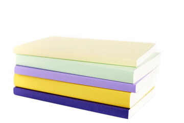 Colored books with blank spine stacked, isolated on a white background