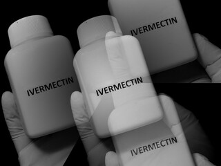 Healthcare worker holding bottle with ivermectin pills, treatment of covid 19