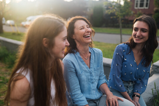 Mother and daughters out for an evening walk in neighborhood tog