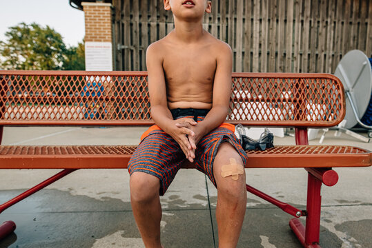 Boy in time out on bench.