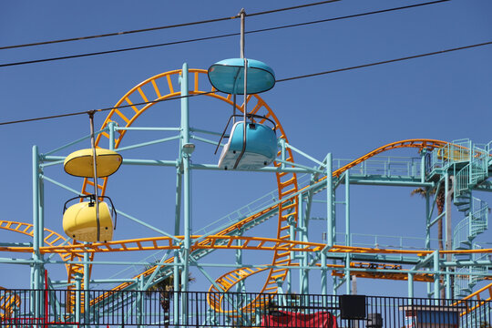 Sky ride with roller coaster in the background