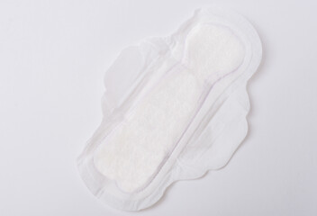 Photo of an opened white and clean menstrual pad over white background.